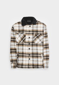 Knappad rutig jacka med svarta, vita och bruna rutor, med en svart sherpa-krage och två bröstfickor.