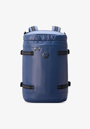 Sac à dos cylindrique bleu marine en matériau imperméable, avec des bretelles ajustables, des fermetures éclair et un logo circulaire à l'avant.