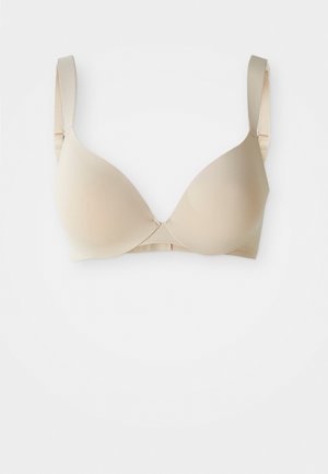 Bež grudnjak s glatkom površinom i laganim jastučićima, s podesivim trakama i žicom ispod, dizajniran za svakodnevnu udobnost i potporu.