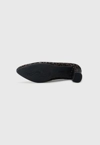 Black slip-on shoe with a leopard print pattern, smooth texture and pointed toe. Features a rubber sole with decorative detailing.