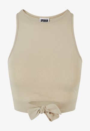 Beige kort top lavet af ribbet stof, med en høj halsudskæring og en knude detalje nederst.