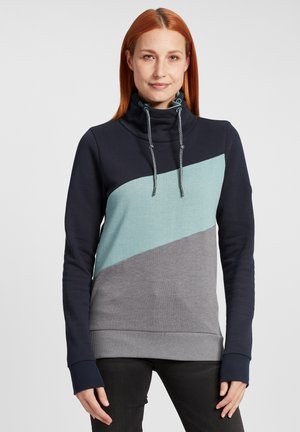 Sweat à capuche avec un col montant, présentant un design en blocs de couleur marine, turquoise et gris. Matériau texturé avec des cordons de serrage contrastés.