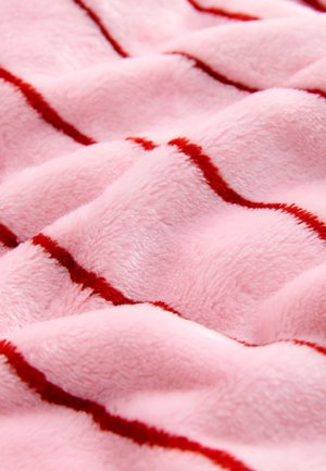 Pink plush fabric with a soft texture, featuring wavy red stripes running across the surface. Smooth and inviting appearance.