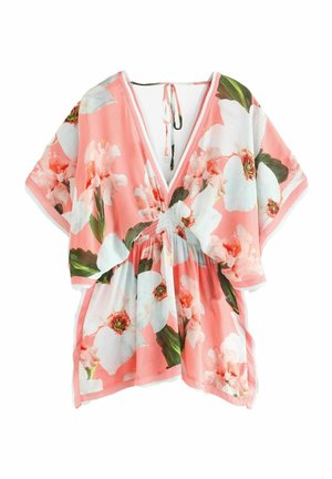 Kukallinen tunika vaaleanpunaisena, jossa on suuret valkoiset ja vihreät kukkakuviot. V-neck-muotoilu, jossa säädettävä nauha takana. Kevyt kangas.