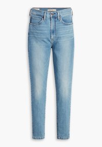 Jeans ajustados de color azul claro, confeccionados en denim, con una cintura alta, cinco bolsillos y un ligero desgastado que les da un aspecto usado.