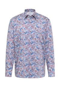 Langarmshirt met een blauw, rood en wit paisleypatroon. Gemaakt van een soepele stof met een spitse kraag en knoopsluiting aan de voorkant.