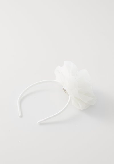 White headband with a large fabric flower accent. The flower features layers of sheer, lightweight material, creating a soft appearance.
