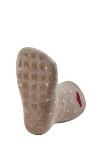 Brown knitted sock with white polka dots and red accent. Textured anti-slip grip on the bottom with a checkered pattern.