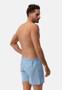 Costumini da bagno a righe blu chiaro con vita elasticizzata. Tessuto morbido con una texture liscia, caratterizzati da una vestibilità rilassata e lunghezza a metà coscia.