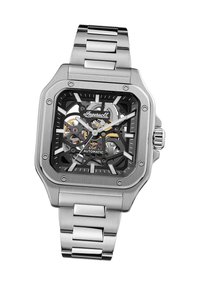 Zilveren roestvrijstalen automatisch horloge met vierkant zwart dial, transparante kast, grote uurmarkeringen en een metalen schakelarmband.