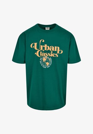 Green cotton t-shirt with short sleeves and a crew neck. Features orange text: "Urban Classics" and globe graphic, stating “We do it for the culture.”