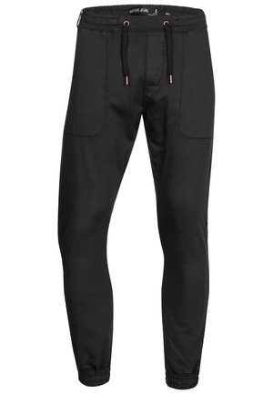 Schwarze Jogginghosen aus leichtem Material, mit elastischem Bund, Kordelzug und elastischen Bündchen. Verfügt über zwei Seitentaschen.