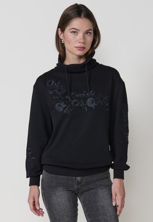 Sudadera negra con cuello alto, con bordado de flores y lentejuelas en el pecho y las mangas. Hecha de una suave mezcla de algodón.