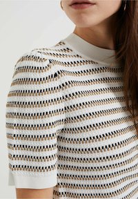 Suéter de punto de manga corta en blanco con rayas horizontales en negro y marrón, con un cuello de canalé y un patrón texturizado.