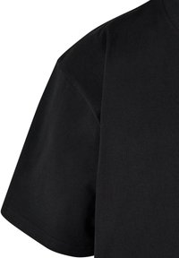 Black cotton t-shirt with a loose fit, short sleeves, and a crew neckline. Fabric appears smooth with minimal seams and stitching details.