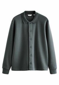 Chemise à manches longues vert foncé avec col et six boutons sur le devant.