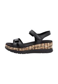 Sandale en cuir noir avec deux brides, semelle en liège texturé, talon compensé, et base en caoutchouc flexible, avec des fermetures réglables.