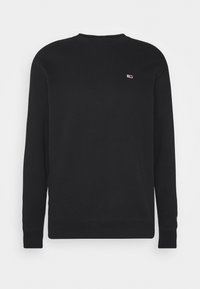 Sudadera negra con cuello redondo, mangas largas y puños de canalé. Presenta un pequeño logo en el pecho. Fabricada con un tejido suave.