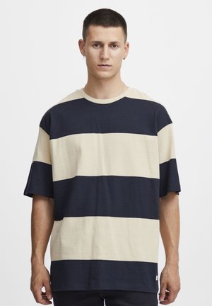 Striped short-sleeve t-shirt in navy and light beige cotton. Loose fit with crew neckline, featuring wide horizontal stripes across the body.