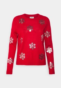 Czerwony sweter z dzianiny z metalicznymi, srebrnymi wzorami śnieżynek. Okrągły dekolt, długie rękawy i ściągacze. Miękka struktura.
