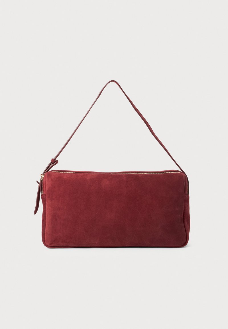 Burgundy suede shoulder bag with a single strap, flat rectangular shape, and gold zipper detail. Smooth texture with minimalistic design.