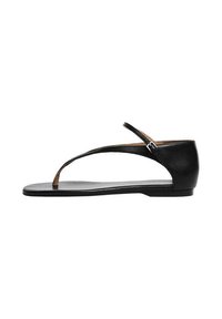 Black leather sandal with a flat sole, featuring a T-strap design and an adjustable ankle strap for a secure fit. Smooth texture and minimalistic style.