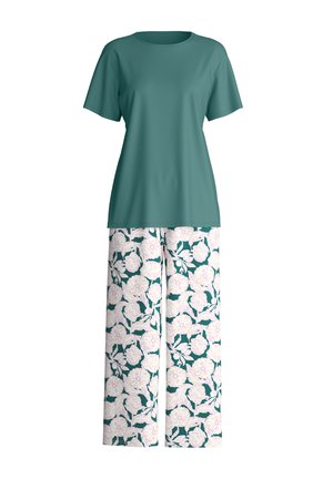 Chemise à manches courtes couleur sarcelle associée à un pantalon à jambes larges avec un motif floral blanc et rose clair sur un fond vert foncé.