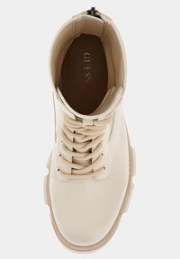 Beige lace-up ankle boots with a smooth glossy finish, rounded toe, sturdy sole, and padded collar; embossed logo on insole.