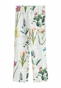 Pantalon blanc à taille élastique avec des imprimés botaniques de plusieurs fleurs étiquetées, dont la lavande, le chèvrefeuille et les glaïeuls.