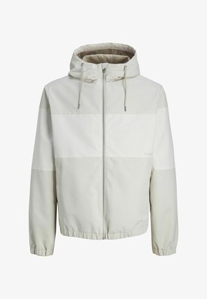 Lagani kaput s kapuljačom u svijetlosivoj boji s zatvaračem sprijeda, s horizontalnim prugama i elastičnim manžetama. Glatka, vodoodbojna tkanina.