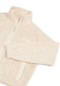 Fleece jaku ar rāvējslēdzēju Gaiši bēšā krāsā ar mīkstu, teksturētu virsmu. Tam ir augsta apkakle un gaišas krāsas rāvējslēdzēja aizdare.