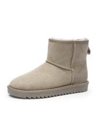Beige suede ankle boot with fleece lining, flat sole, and pull tab at the back, designed for winter wear.