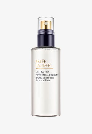 Transparent spray bottle with a silver and navy twist cap. Features gold text on the label. Contains a clear makeup setting mist.