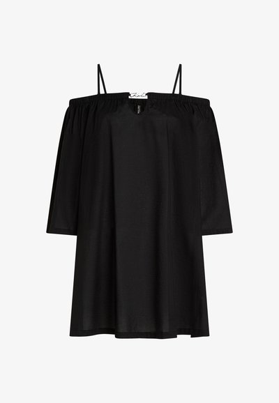 Haut noir à épaules nues avec des manches courtes, fabriqué dans un tissu lisse. Présente des bretelles fines et un design ample et fluide.