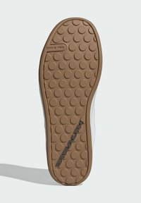 Suola della scarpa con una texture in gomma a strisce, caratterizzata da motivi circolari in rilievo, logo "STEALTH" nero e un bordo curvo per maggiore flessibilità.