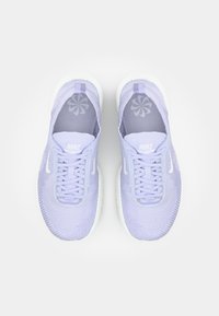 Heledad lilla sportjalatsid tekstuurses võrguülemises, valge tald ja paelad. Omab Nike brändingut keeles ja sisetaldades.