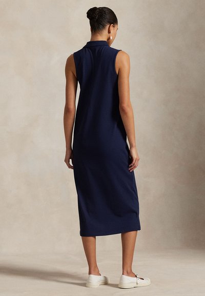 Navy sleeveless dress with a collared neckline, ankle-length, made from a smooth fabric. Features a relaxed fit and side slits.