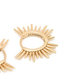 Gold-tone metal earrings with a sunburst design, featuring sharp spikes and a circular base. Engraved with "ALLSAINTS."