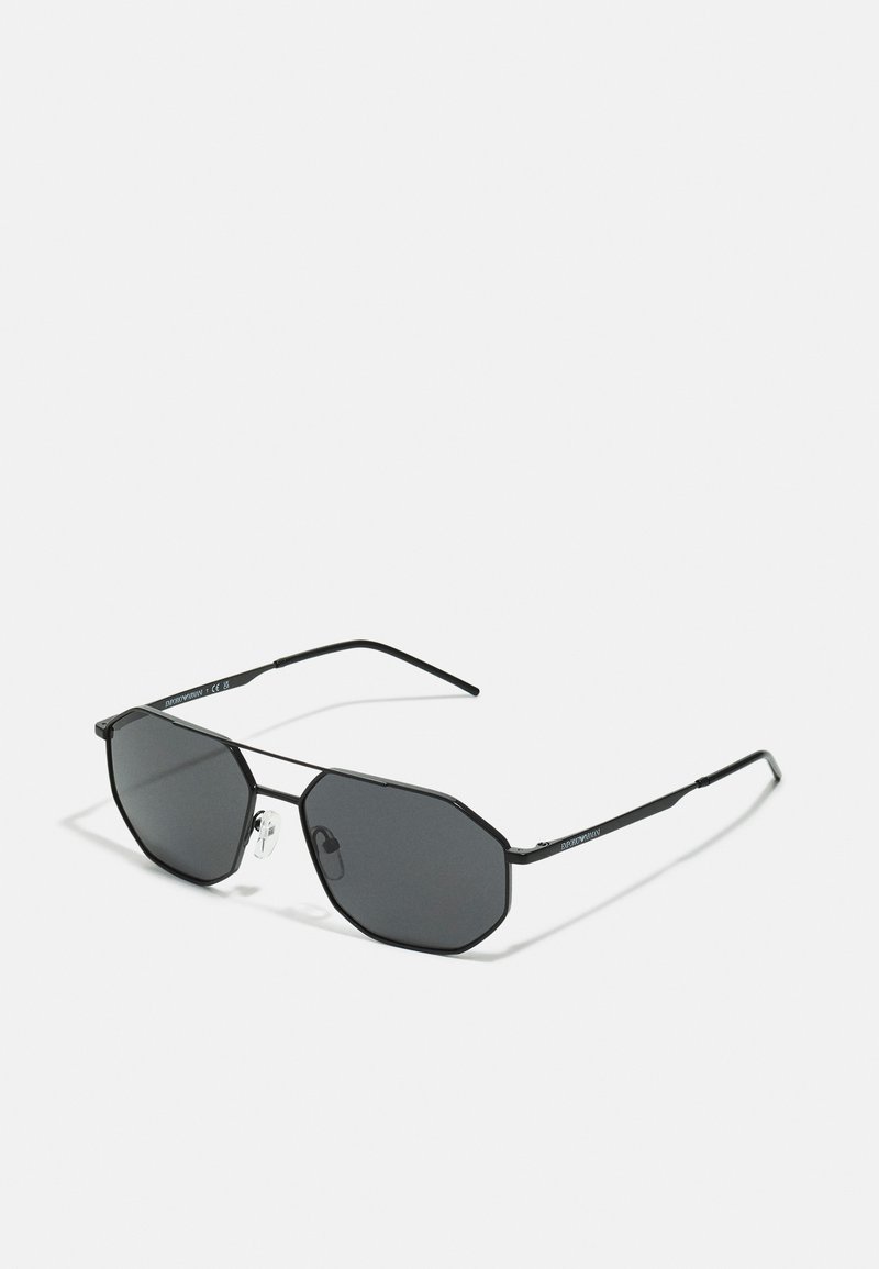 Ochelari de soare octagonali negri cu lentile întunecate, rame subțiri din metal negru și suporturi pentru nas transparente. Prezintă un design minimalist și linii elegante.