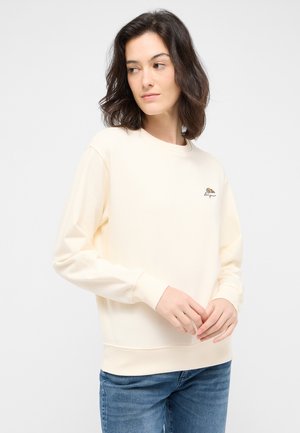 Felpa color crema con colletto rotondo e maniche lunghe. Presenta un piccolo design ricamato sul petto. Materiale in cotone.