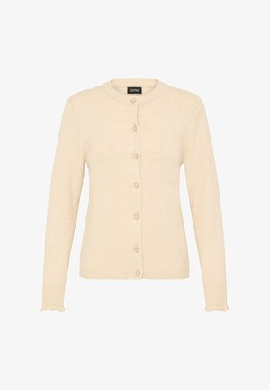 Beige neulejakku pyöreällä kauluksella, täyspitkillä hihoilla ja nappisuljennalla. Sisältää ribbireunat, joissa on hienovaraisia frilliviiltoja.