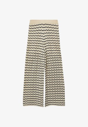 Pantalon large couleur crème à rayures horizontales noires ondulées et taille haute, avec un motif tricoté texturé sur toute la surface.