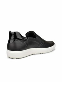 Scarpe slip-on in pelle nera con un accento lucido nero sul tallone, suola bianca e punta rotonda, dotate di pannelli elastici laterali per il comfort.