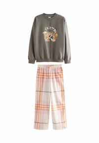 Gray sweatshirt with a multicolored graphic and patterned plaid loose-fitting pants in orange and white with an elastic waistband.