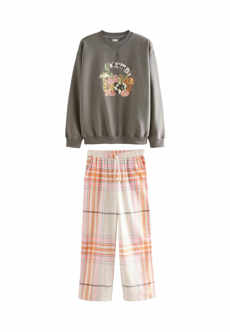 Gray sweatshirt with a multicolored graphic and patterned plaid loose-fitting pants in orange and white with an elastic waistband.