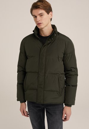 Olive green puffer jacket with a high collar, featuring snap closures, side pockets, and a quilted design. Worn over a black top.
