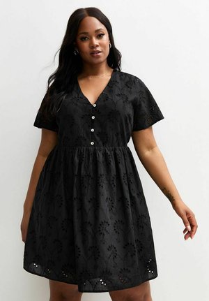 Black short-sleeved dress with a V-neck, button front, and floral embroidery. Flared skirt with delicate cut-out accents at the hem.