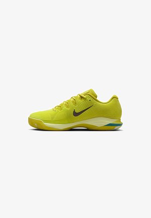 Limegrüner Sportschuh mit einer strukturierten Oberseite, ausgestattet mit einem schwarzen Nike-Swoosh, einer gepolsterten Sohle und einem hellblauen Akzent an der Ferse.