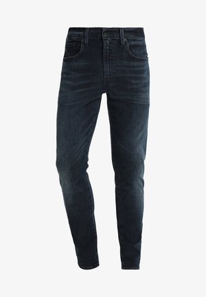 Tmavě modré skinny džíny vyrobené z denimu, s mírným vzestupem v pase, designem s pěti kapsami a jemným zesvětlením na nohách.