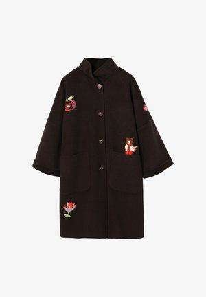 Ruskea villakangastakki, jossa on kaulus, kirjailtuja kukkakuvioita ja karhupainatus. Takissa on kaksi etutaskua ja nappikiinnitys.